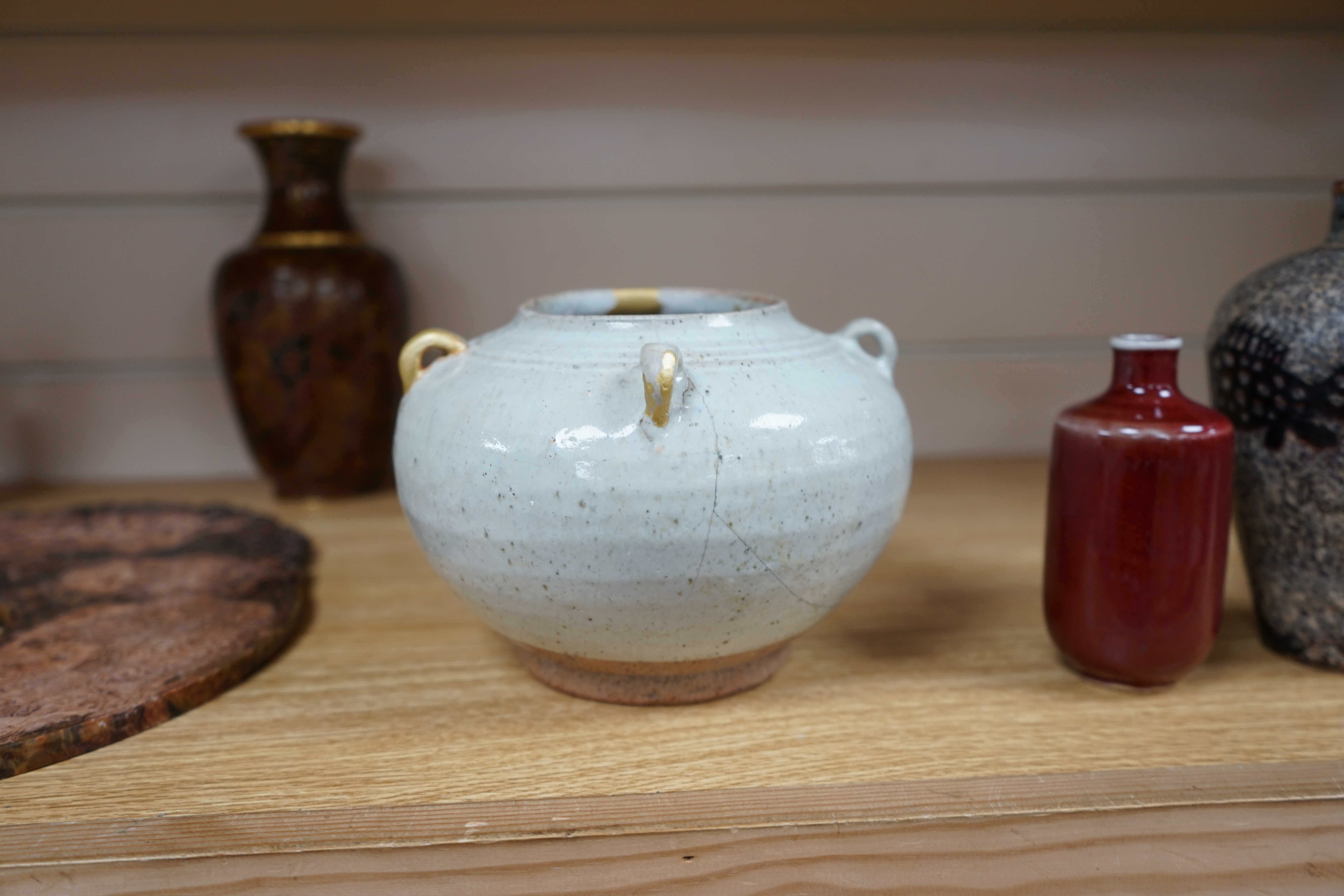 Chinese ceramics comprising a white glazed jar, Jin-Yuan dynasty, hare’s fur type bowl, a cut paper silhouette vase and a sang de boeuf glazed vase, largest 17cm in diameter (4). Condition - poor to good